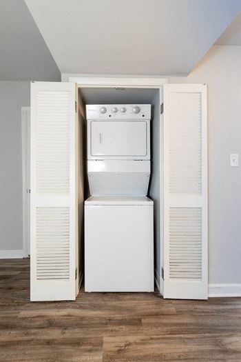 an empty laundry room with a washer and dryer in it at McDonogh Village Apartments & Townhomes, Randallstown, MD